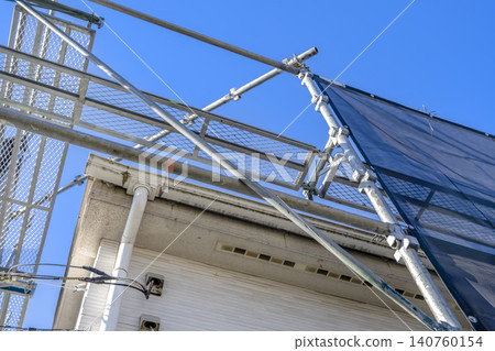 Roof renovation work immediately after commencement: old roof and temporary scaffolding. Roof renovation work immediately after commencement: old roof and temporary scaffolding. 140760154