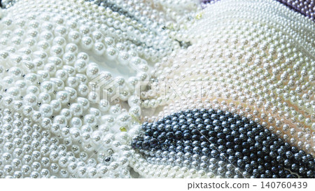 High angle view of various pearl necklaces in white, pink, and black colors background. High angle view of various pearl necklaces in white, pink, and black colors background. 140760439