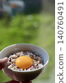 Sixteen-grain rice with raw egg, eaten by the window. 140760491