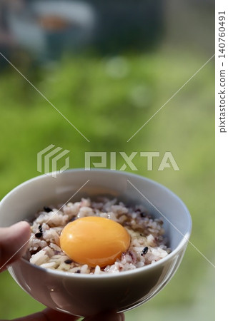 Sixteen-grain rice with raw egg, eaten by the window. Sixteen-grain rice with raw egg, eaten by the window. 140760491
