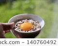 Sixteen-grain rice with raw egg, eaten by the window. 140760492