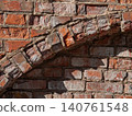 Fragment of a decorative blind arch on a ruined red brick wall architectural texture 140761548