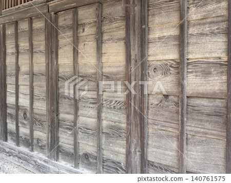 The wall of an old wooden building 140761575