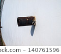 Abstract geometry of rusty metal downspout pipes on a white plaster wall 140761596