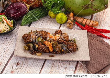 Savory stir fried dish with shrimp and vegetables on rustic wooden table Savory stir fried dish with shrimp and vegetables on rustic wooden table 140761743