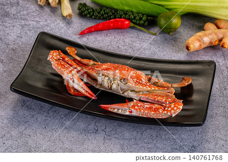 Red spotted crab on black plate with fresh ingredients Red spotted crab on black plate with fresh ingredients 140761768