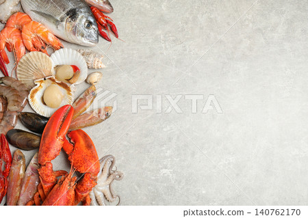 Fresh fish and different seafood on light grey table, flat lay. Space for text Fresh fish and different seafood on light grey table, flat lay. Space for text 140762170