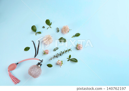 Beautiful composition with bottle of perfume and flowers on white background, flat lay. Space for text 140762197