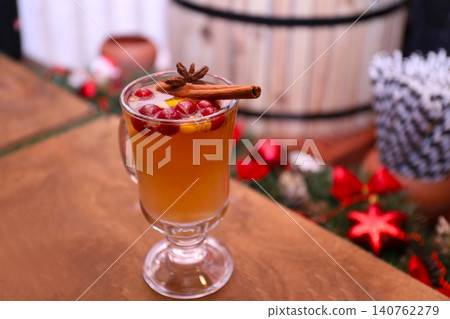 Tasty aromatic mulled wine on wooden table 140762279