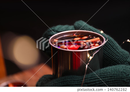 Person with mug of mulled wine on dark background, closeup 140762282