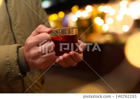 Man with mulled wine at winter fair, closeup 140762283
