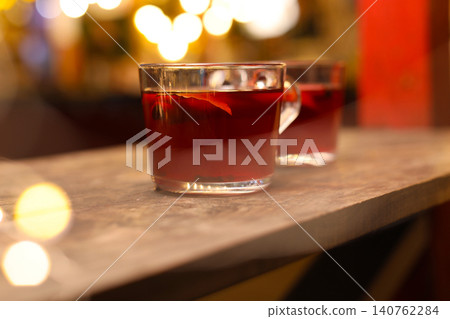 Tasty aromatic mulled wine on wooden table 140762284