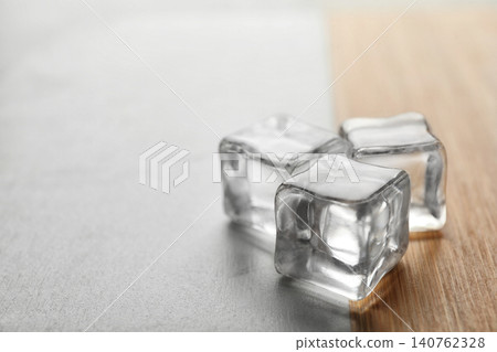 Crystal clear ice cubes on table, closeup. Space for text Crystal clear ice cubes on table, closeup. Space for text 140762328
