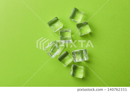 Crystal clear ice cubes on green background, flat lay 140762331