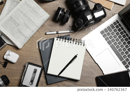Flat lay composition with equipment for journalist on wooden table Flat lay composition with equipment for journalist on wooden table 140762367