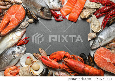 Fresh fish and different seafood on grey table, flat lay. Space for text Fresh fish and different seafood on grey table, flat lay. Space for text 140762445