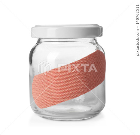 Glass jar with sticking plaster isolated on white 140762511