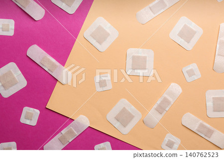 Different types of sticking plasters on color background, flat lay Different types of sticking plasters on color background, flat lay 140762523