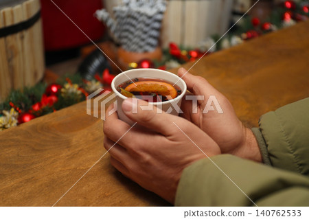 Man with cup of mulled wine at counter, closeup 140762533