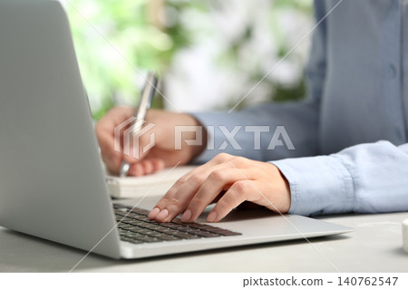 Journalist working with laptop at table, closeup Journalist working with laptop at table, closeup 140762547