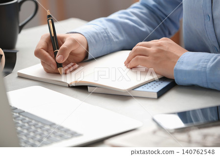 Journalist working at table in office, closeup Journalist working at table in office, closeup 140762548