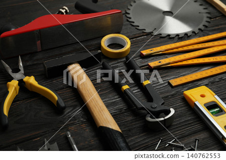 Different carpenter's tools on black wooden background Different carpenter's tools on black wooden background 140762553
