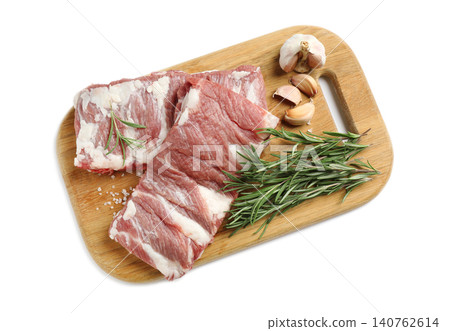 Raw ribs with rosemary, salt and garlic on white background, top view Raw ribs with rosemary, salt and garlic on white background, top view 140762614