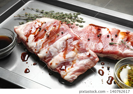 Fresh raw ribs on baking sheet, closeup Fresh raw ribs on baking sheet, closeup 140762617