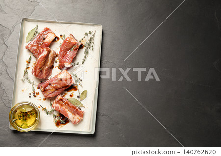Raw marinated ribs on black table, top view. Space for text Raw marinated ribs on black table, top view. Space for text 140762620