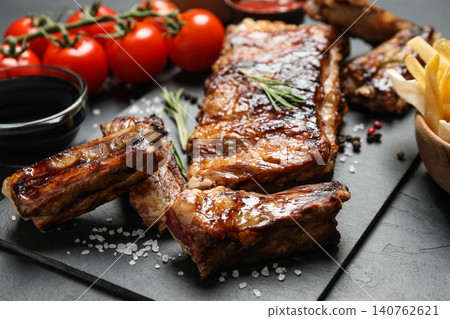Delicious grilled ribs on black table, closeup 140762621