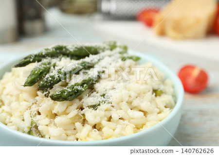 Delicious risotto with asparagus and cheese in bowl, closeup Delicious risotto with asparagus and cheese in bowl, closeup 140762626