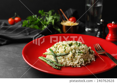 Delicious risotto with asparagus served on grey table Delicious risotto with asparagus served on grey table 140762628