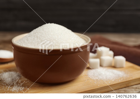 Granulated sugar in bowl on wooden table Granulated sugar in bowl on wooden table 140762636
