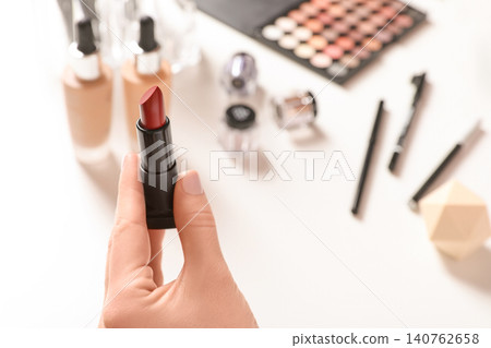 Beauty blogger with lipstick at table, closeup Beauty blogger with lipstick at table, closeup 140762658