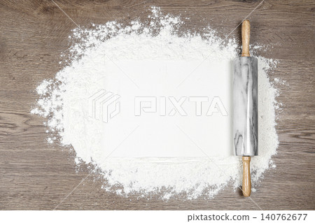 Flour and rolling pin on wooden table, flat lay 140762677