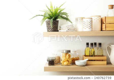 Wooden shelves with dishware and products on white wall. Kitchen interior idea Wooden shelves with dishware and products on white wall. Kitchen interior idea 140762739