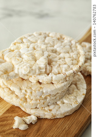 Crunchy rice cakes on wooden board, closeup Crunchy rice cakes on wooden board, closeup 140762783