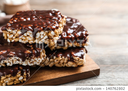 Delicious rice crispy treats on wooden table, closeup 140762802