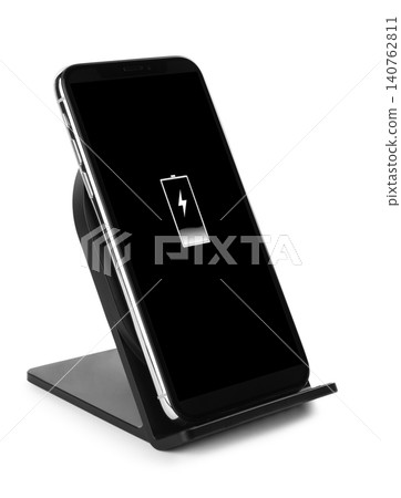 Mobile phone charging with wireless pad isolated on white Mobile phone charging with wireless pad isolated on white 140762811