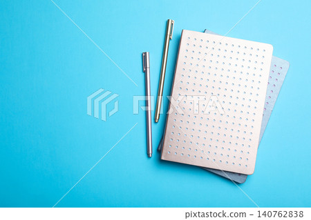 Stylish notebooks and pens on light blue background, flat lay. Space for text 140762838