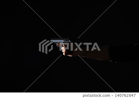 Professional killer with gun on black background, closeup Professional killer with gun on black background, closeup 140762847