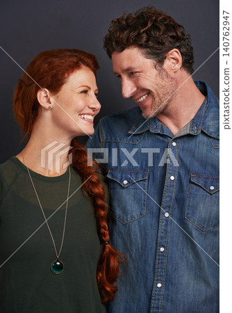 Love, smile and happy couple in studio together with relationship trust, care and support. Romance, casual man and woman embrace on dark background with commitment, loyalty and affection in marriage Love, smile and happy couple in studio together with relationship trust, care and support. Romance, casual man and woman embrace on dark background with commitment, loyalty and affection in marriage 140762947