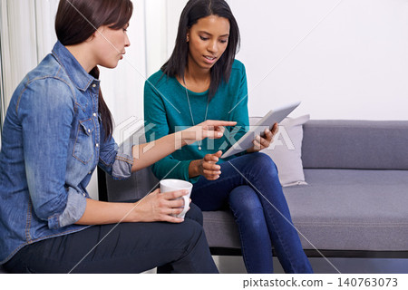 Business people, women and tablet in meeting with planning for digital project, creative feedback and discussion on sofa. Collaboration, employees and technology on couch in office with communication 140763073