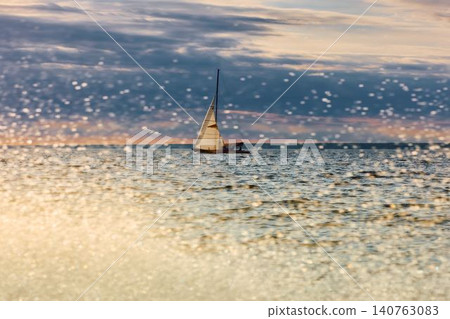 Vintage sailing boat through splashing water at sunset, Sailing regatta in the Gulf of Finland at sunset, hot race of several yachts, teamwork 140763083