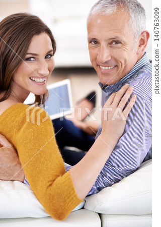 Couple, tablet and happy for portrait on sofa for hug, care or bonding with tech in home living room. People, woman and mature man with digital touchscreen on lounge couch to relax with search on web Couple, tablet and happy for portrait on sofa for hug, care or bonding with tech in home living room. People, woman and mature man with digital touchscreen on lounge couch to relax with search on web 140763099