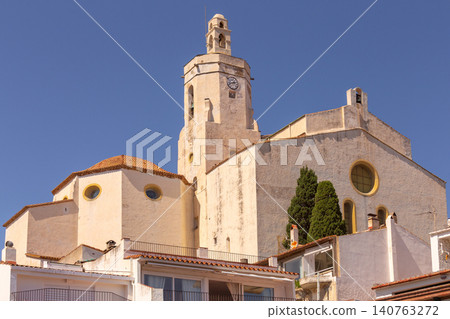 Historic Santa Maria Church rises above the white houses of Cadaques on the Costa Brava, showcasing the traditional architecture of this Mediterranean coastal town. Historic Santa Maria Church rises above the white houses of Cadaques on the Costa Brava, showcasing the traditional architecture of this Mediterranean coastal town. 140763272