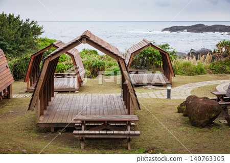 Front view of coastal wooden camping shelter 140763305