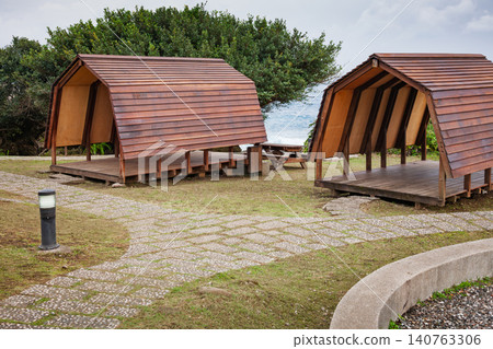 Taiwan coastal campsite with twin wooden shelters Taiwan coastal campsite with twin wooden shelters 140763306