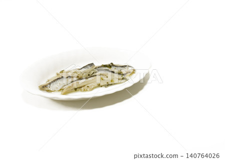 Traditional Spanish pickled white anchovies marinated in vinegar, garlic, and parsley on a white plate. Top stock photo for Mediterranean restaurant menus, culinary blogs, and food marketing. Traditional Spanish pickled white anchovies marinated in vinegar, garlic, and parsley on a white plate. Top stock photo for Mediterranean restaurant menus, culinary blogs, and food marketing. 140764026