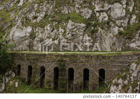Stone bridge over a canal in Cares river valley. 140764137